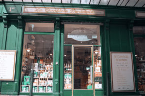 Storefront with green facade and bottles