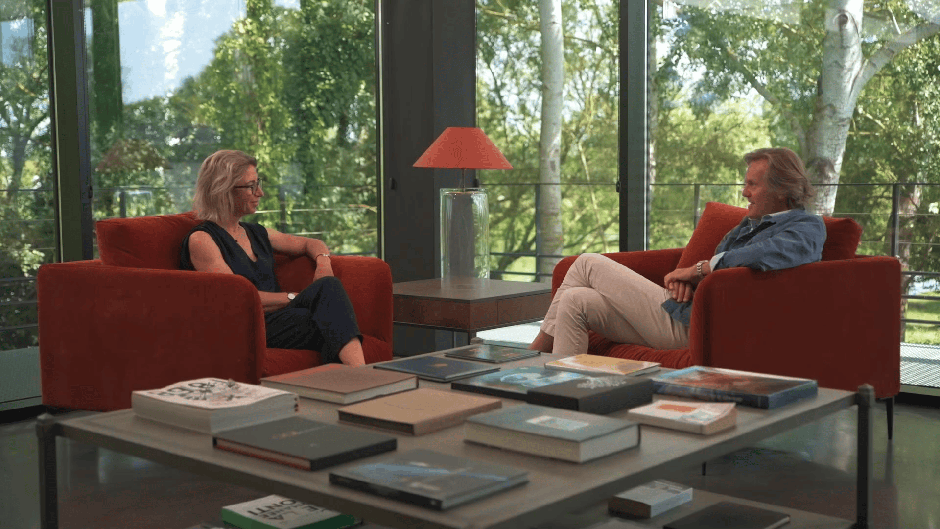 Two people in modern room with books