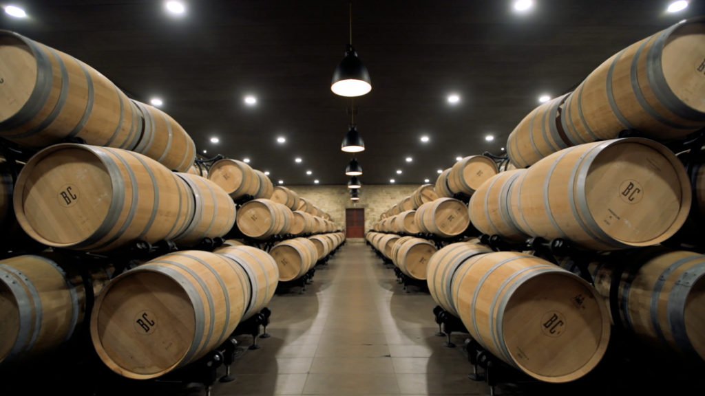 twins-chateau-brane-cantenac-symmetrical-wooden-barrels-in-cellar-negociant-bordeaux