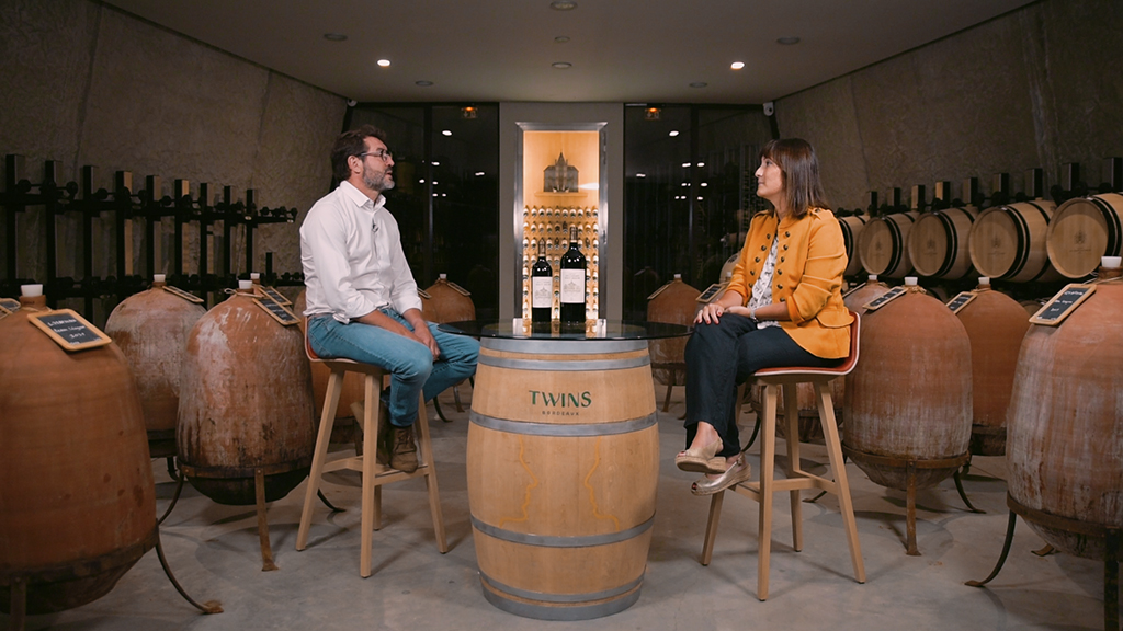 People in wine cellar with bottles